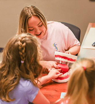 A Speech Therapist is Using a Dental Model During a Pediatric Speech Therapy Session in Norwood, MA 